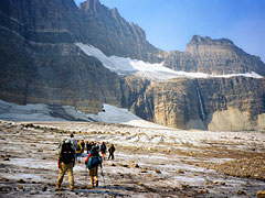Hikers walking on the Grinnell Glacier surface